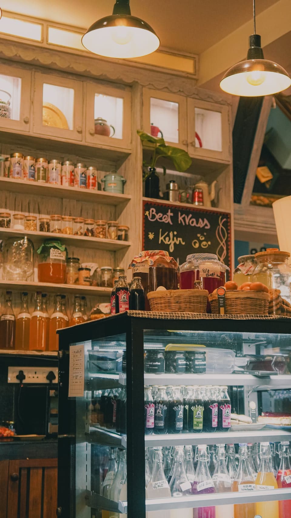 Cozy cafe interior with warm wood shelving and a softly lit counter